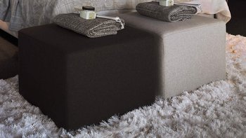 Hellgraues JOKA Noblesse Boxspringbett in dunklem Wellness-Ambiente mit Holz- und Steinwand