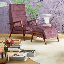 oka Laguna lilafarbener und rosa Fauteuil mit Hocker vor floral gemusterter Tapete